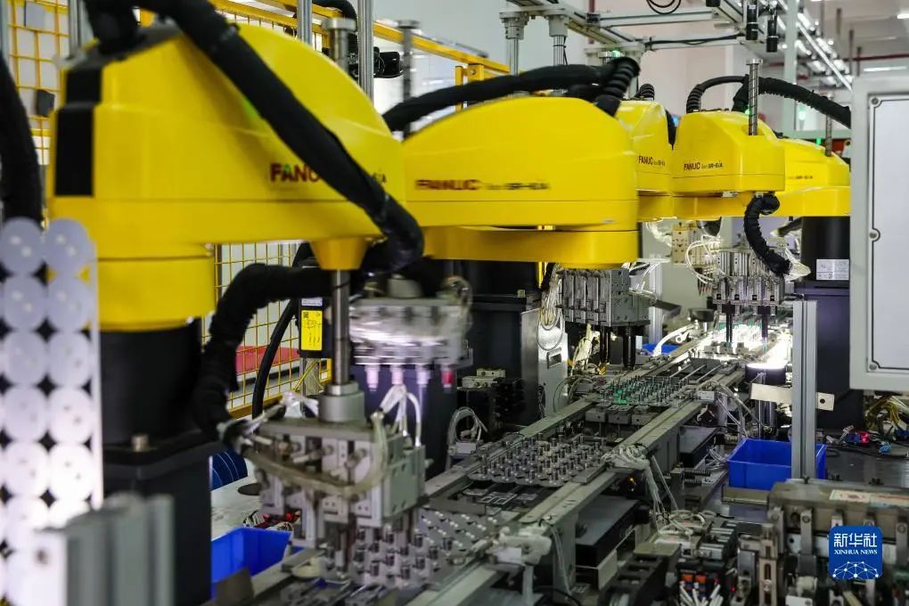 This is an industrial robot photographed at the FoShan Lighting Gao Ming production base.